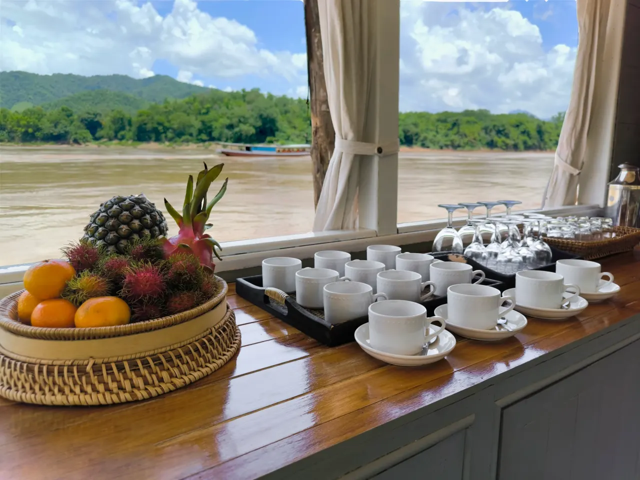 Tropical fruit and coffee service on board, with the Mekong River in the background