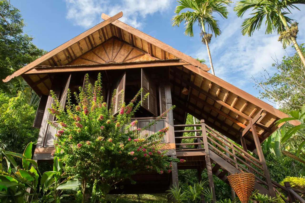 Teak bungalow on stilts surrounded by tropical garden at Luang Say Lodge, Pakbeng
